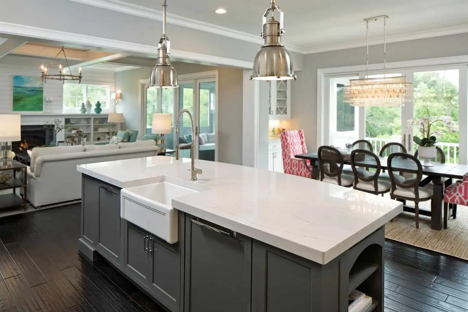 Cambria photograph of its Ella quartz design on a grey island with a farmhouse sink in an open kitchen, not a Kitchen Cabinets and Beyond project
