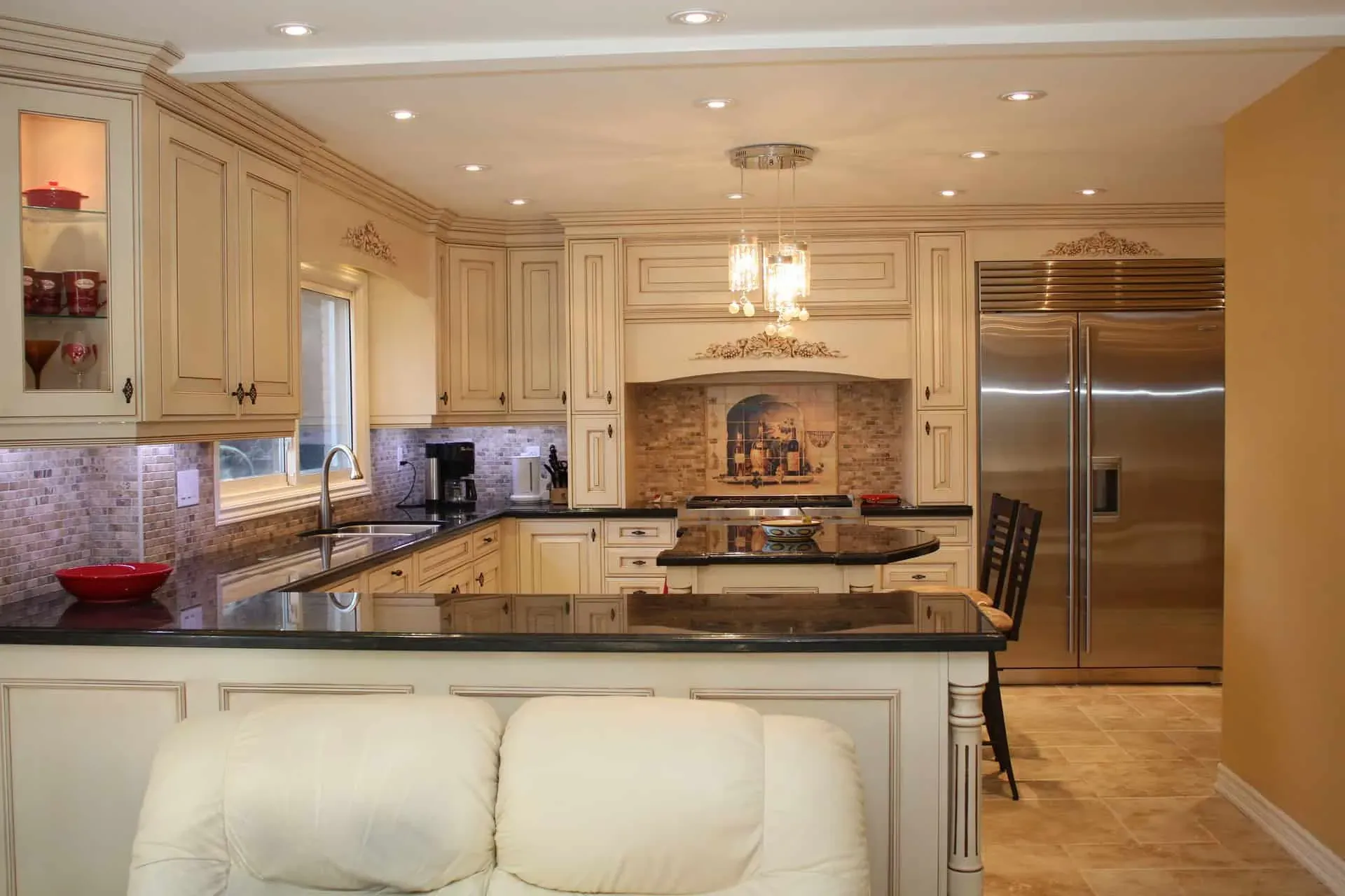 Cream panelled cabinets and dark stone countertops in a custom Anaheim kitchen remodel