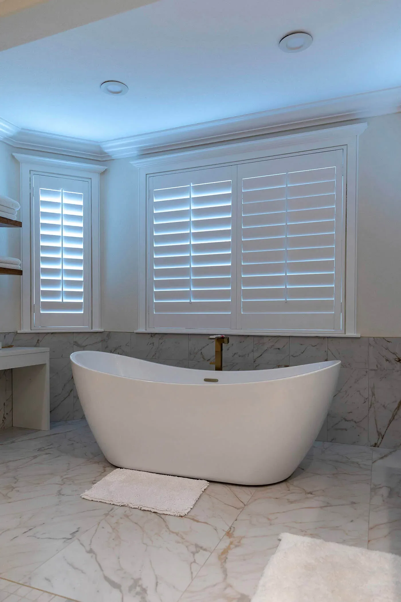 Yorba Linda bathroom with a freestanding slipper tub beneath shuttered windows