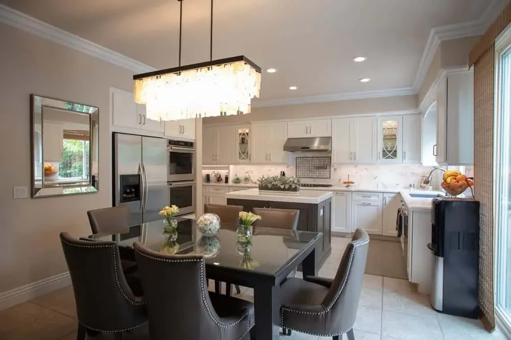 Irvine kitchen remodel with white cabinets and a crystal chandelier over the dining table