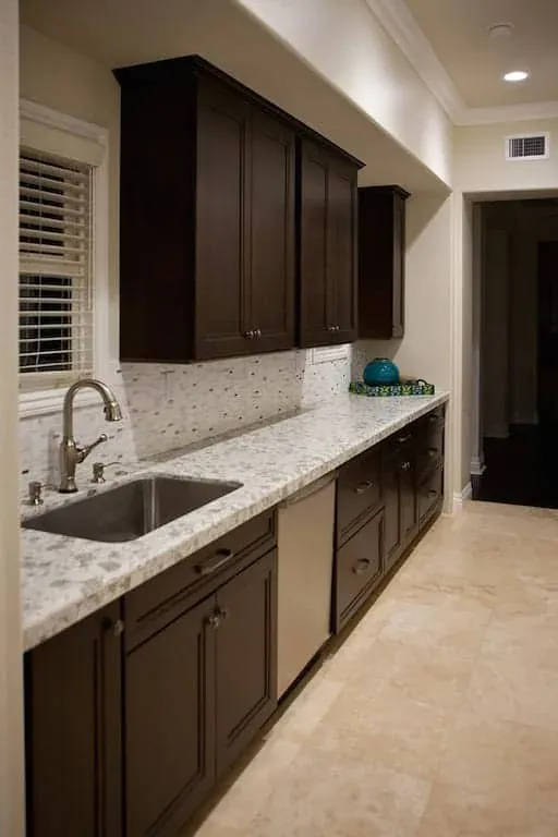 Custom kitchen cabinets fitted in a Coto de Caza home with brushed hardware