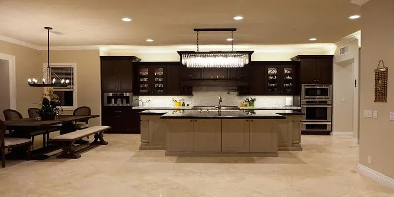 Placentia kitchen remodel with espresso cabinetry, a long island and a linear crystal chandelier