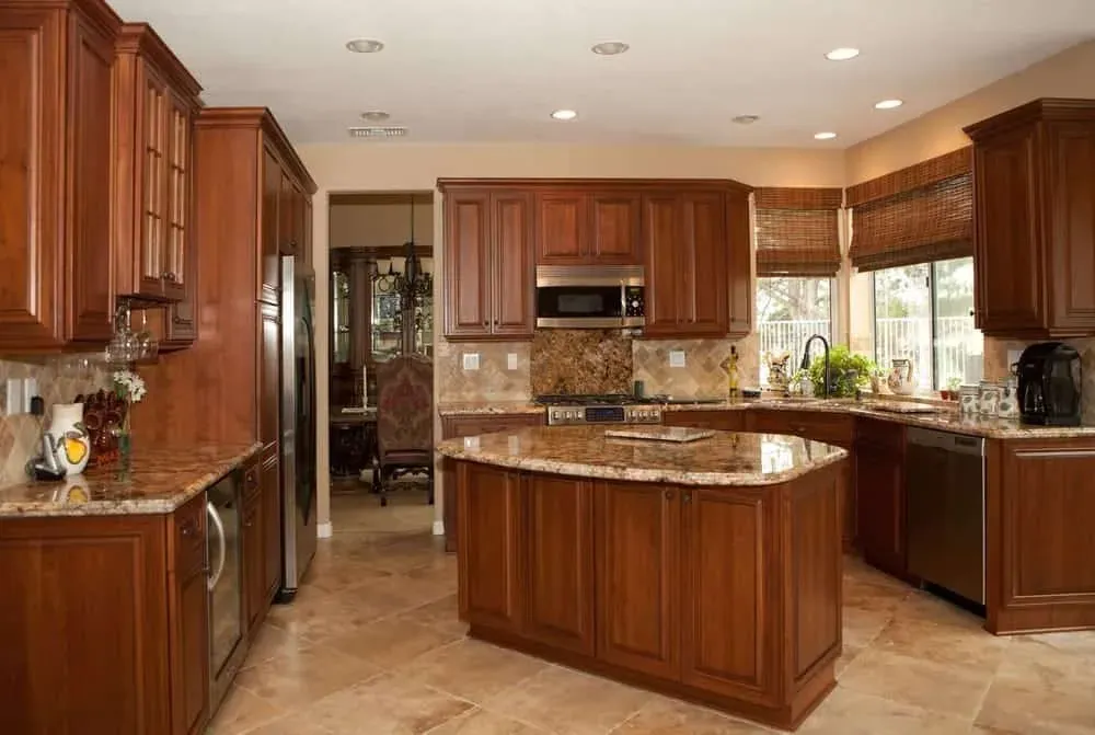 Cherry kitchen with a granite island and a window over the sink