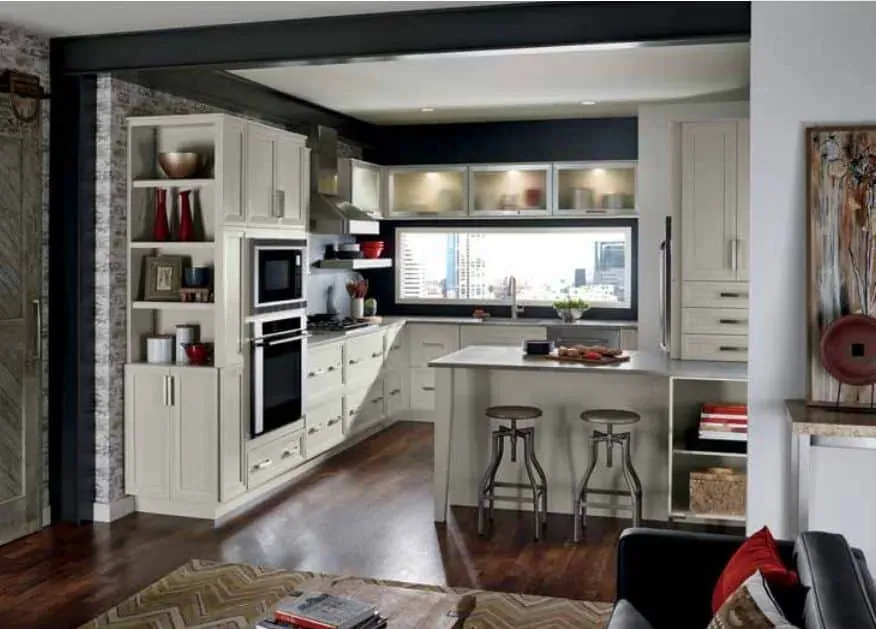 White kitchen with black accents, open shelving and an island with metal stools