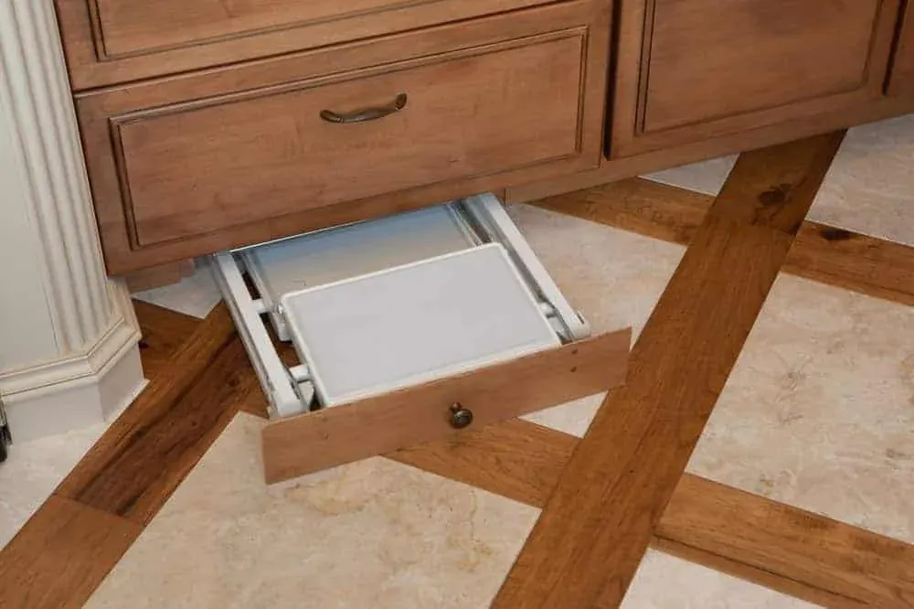 Cabinet drawer with a folding step stool that pulls out from the toe kick