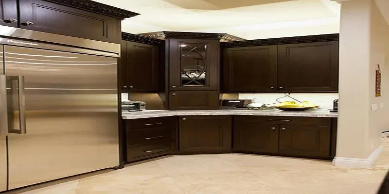 Espresso cabinets with cream counters and a stainless side-by-side refrigerator