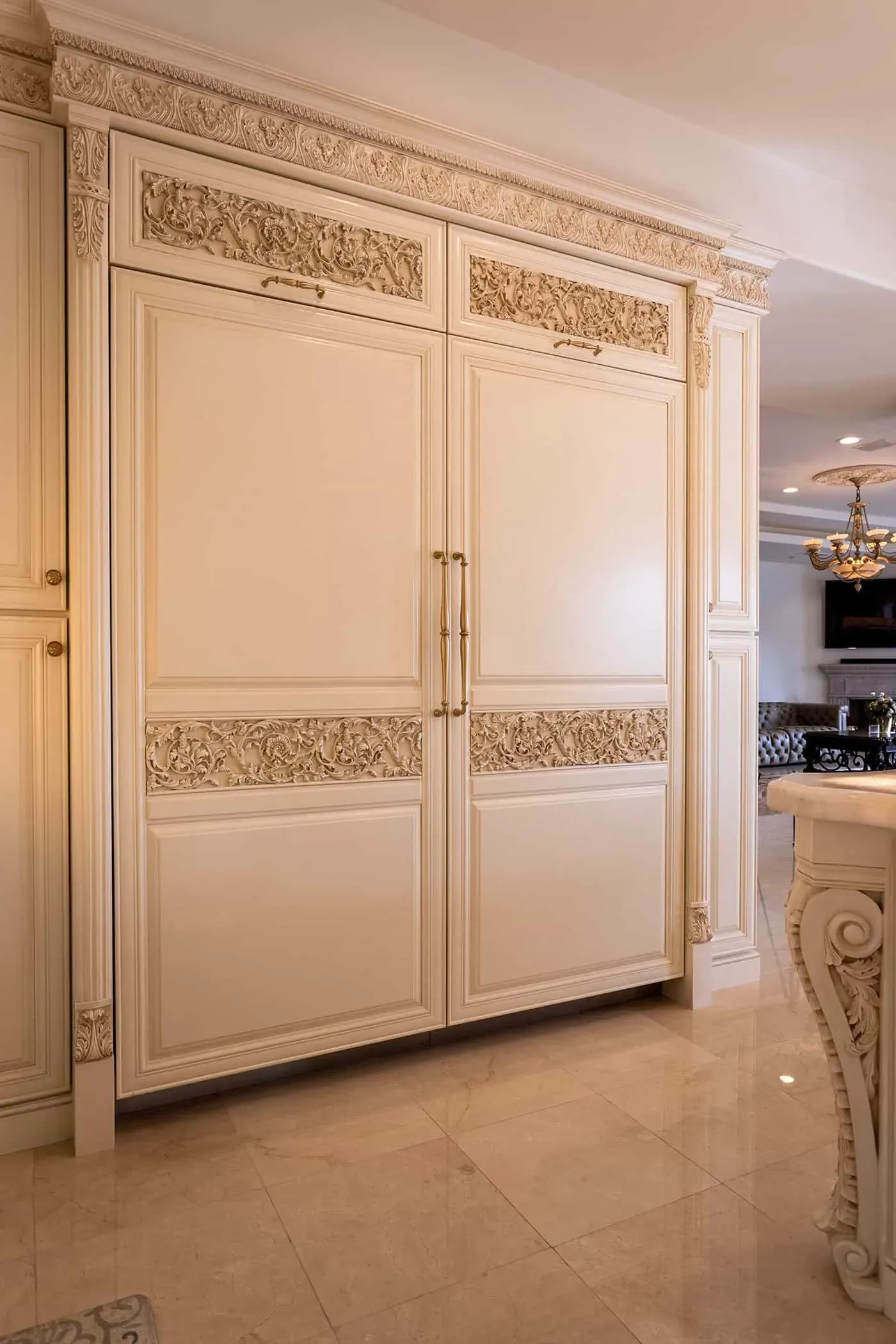 Panelled cream refrigerator front with a carved frieze panel