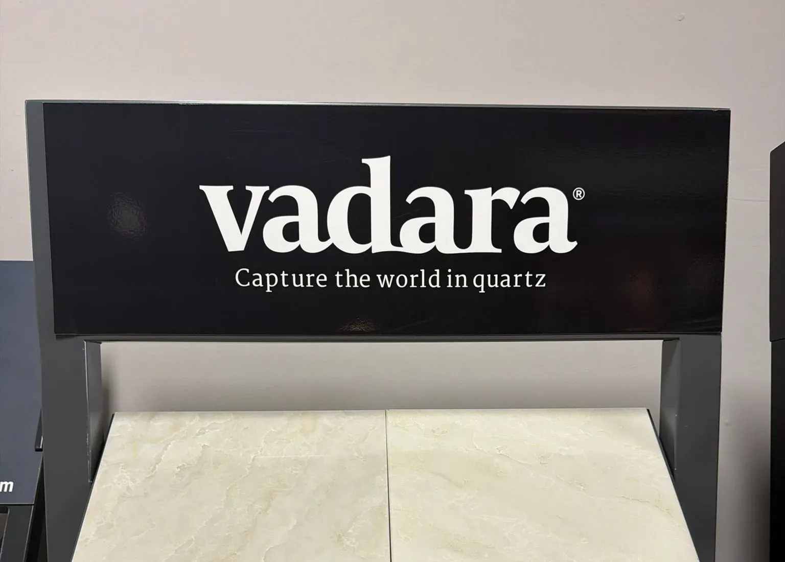 Vadara quartz sample rack in our Anaheim showroom showing the cream Braewind and Canyon Choir samples side by side